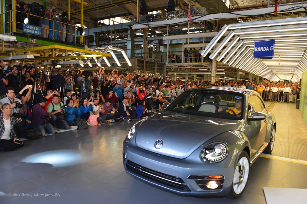 Beetle car drives across factory floor