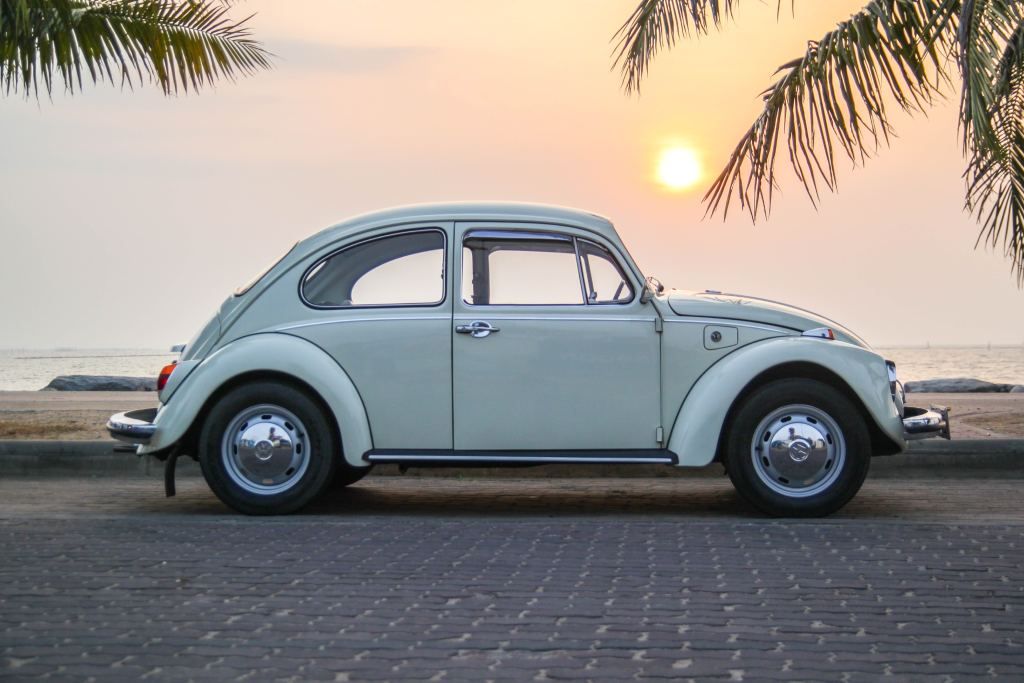 Vintage VW Beetle next to ocean